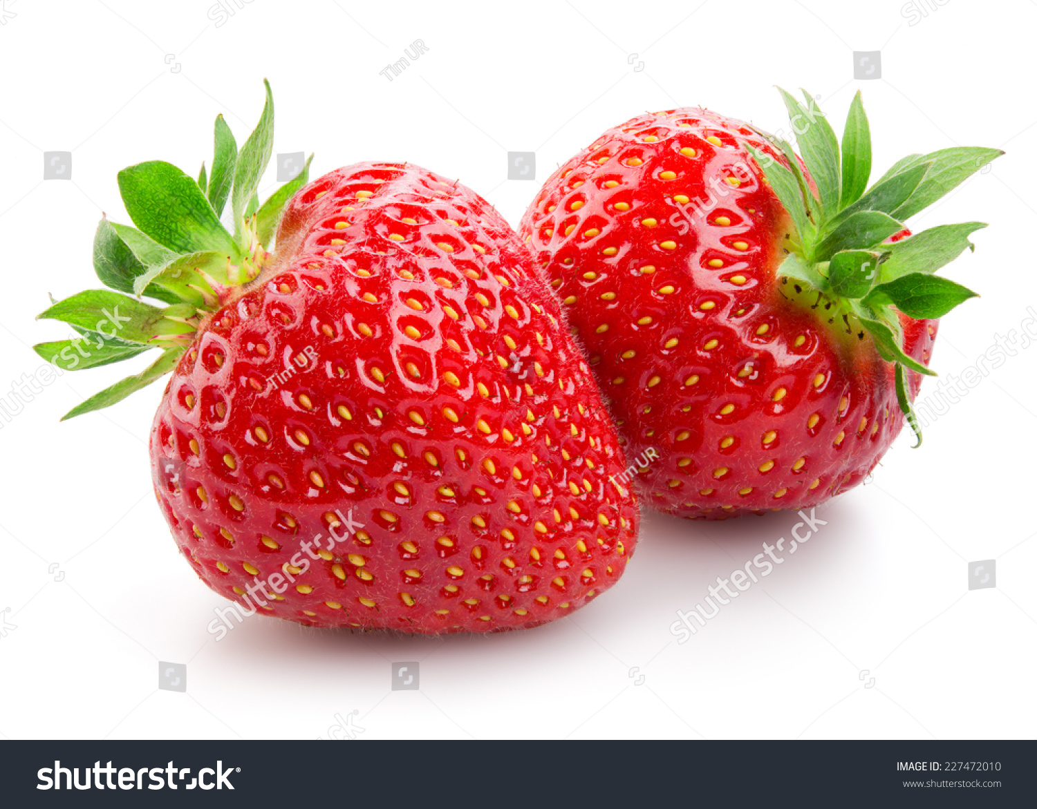 Two strawberries close up on white background #227472010