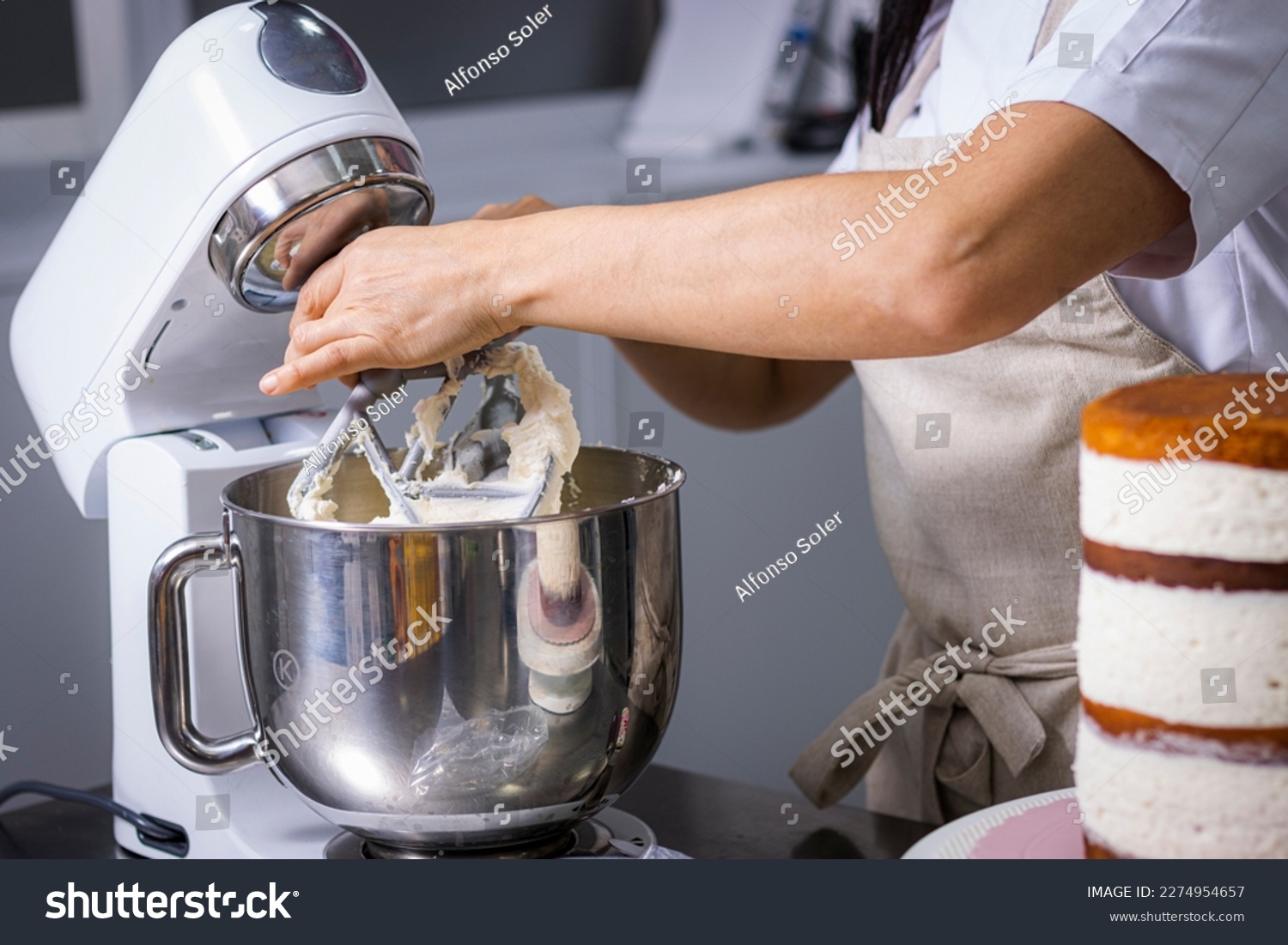 Close-up of a professional chef's hands working the batter with a food processor. #2274954657