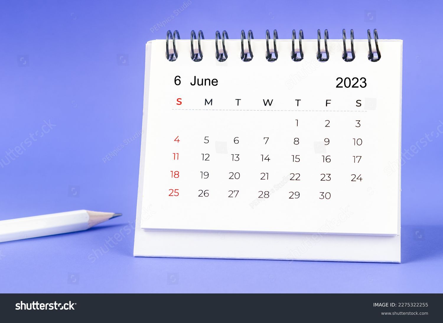 June 2023 Monthly desk calendar for 2023 year with pencil on purple background. #2275322255