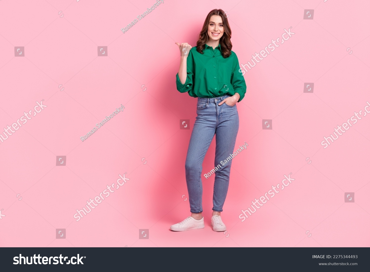 Full length photo of funny cute lady dressed green blouse pointing thumb emtpy space isolated pink color background #2275344493