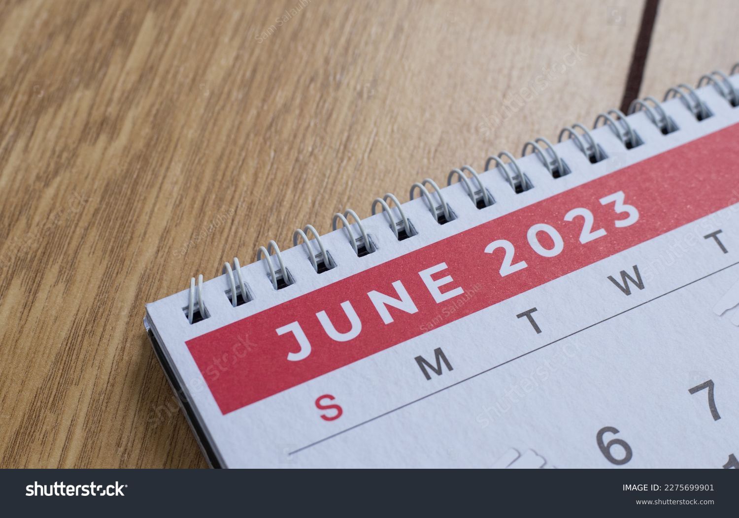 Closeup shot of a 2023 calendar, "June page". Selective focus shot of a calendar, focused on "June, 2023". #2275699901