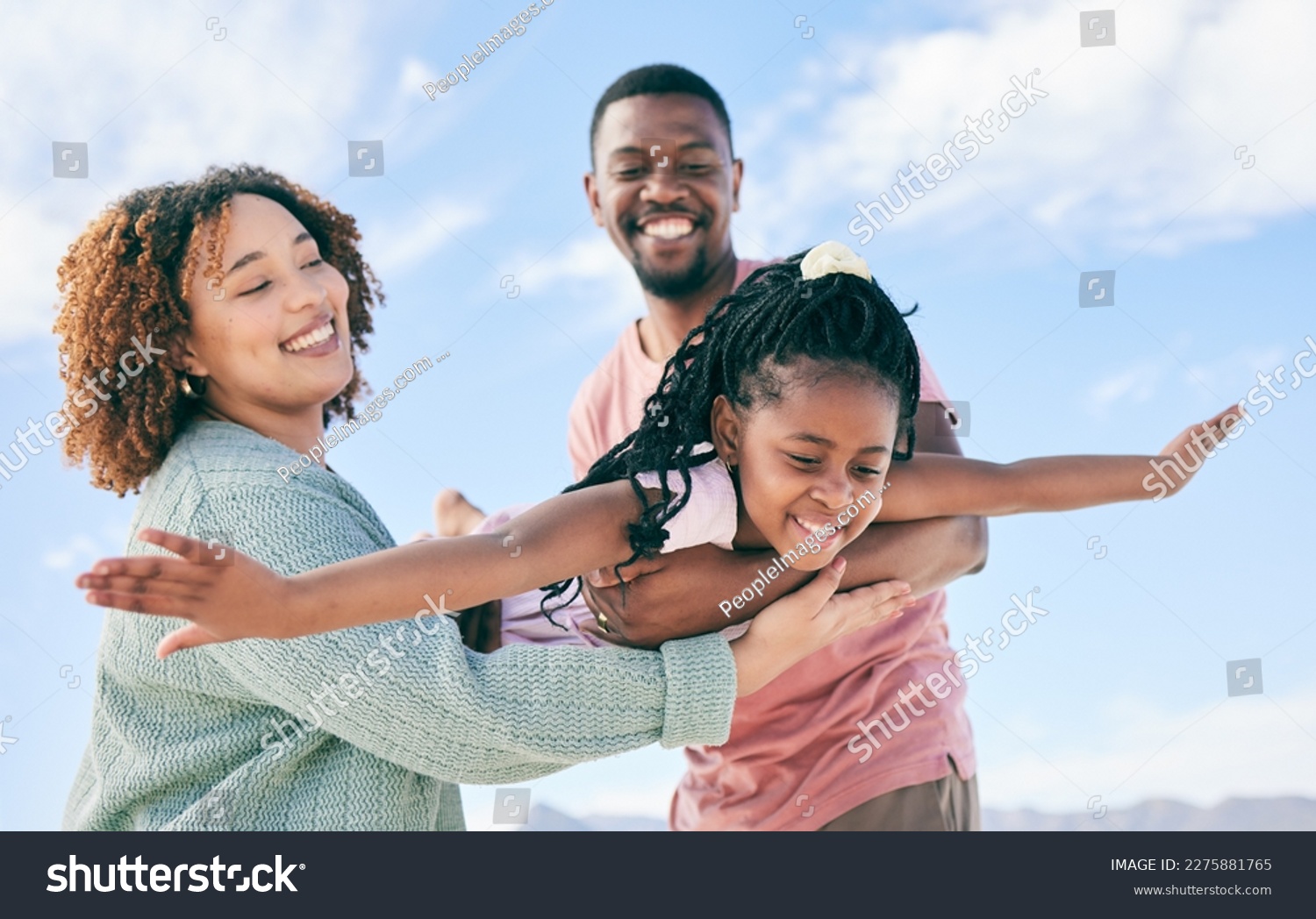 Happy family, fly or girl with parents at beach on summer holiday vacation or weekend together. African dad, funny mother or excited child love bonding, laughing or relaxing while playing in nature #2275881765