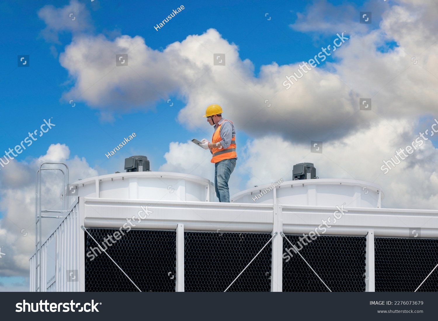 Industry engineer under checking the industry cooling tower air conditioner is water cooling tower air chiller HVAC of large industrial building to control air system. #2276073679