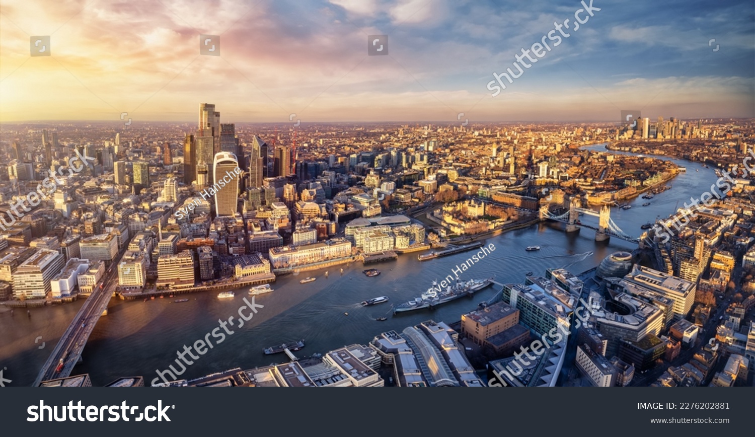 Panoramic sunset view over the skyline of the City of London, England, down the River Thames with Tower Bridge and Canary Wharf district #2276202881