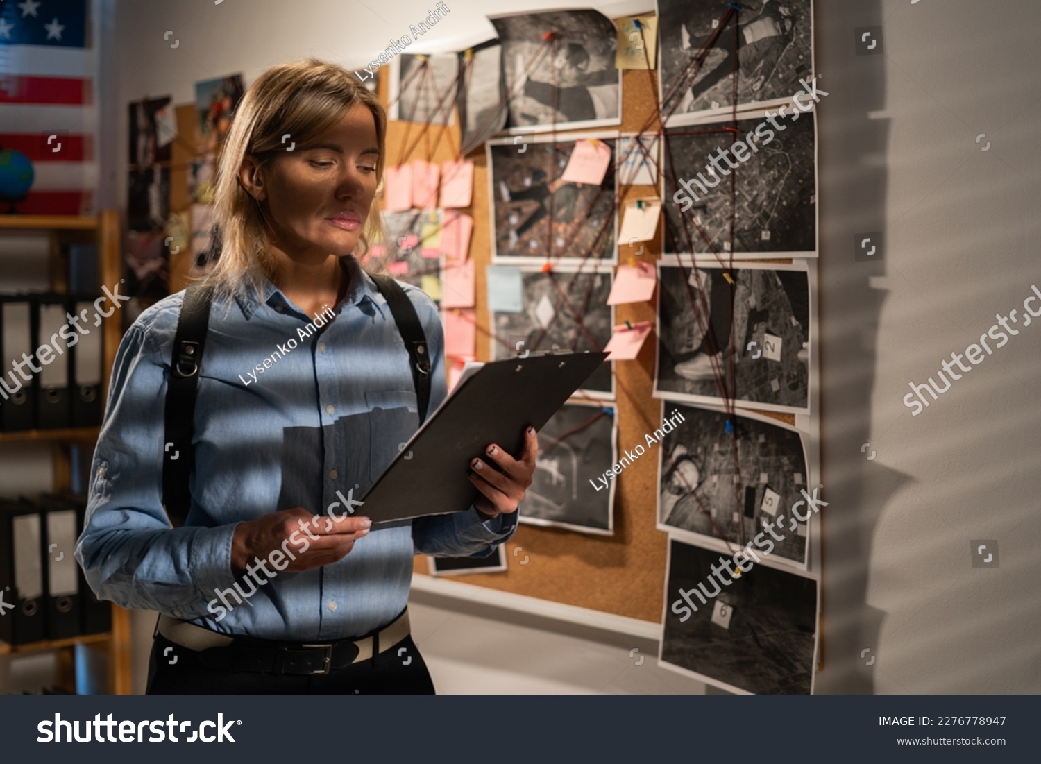 Woman private agent looking at crime investigation board holding clipboard, chasing serial killer. Copy space #2276778947