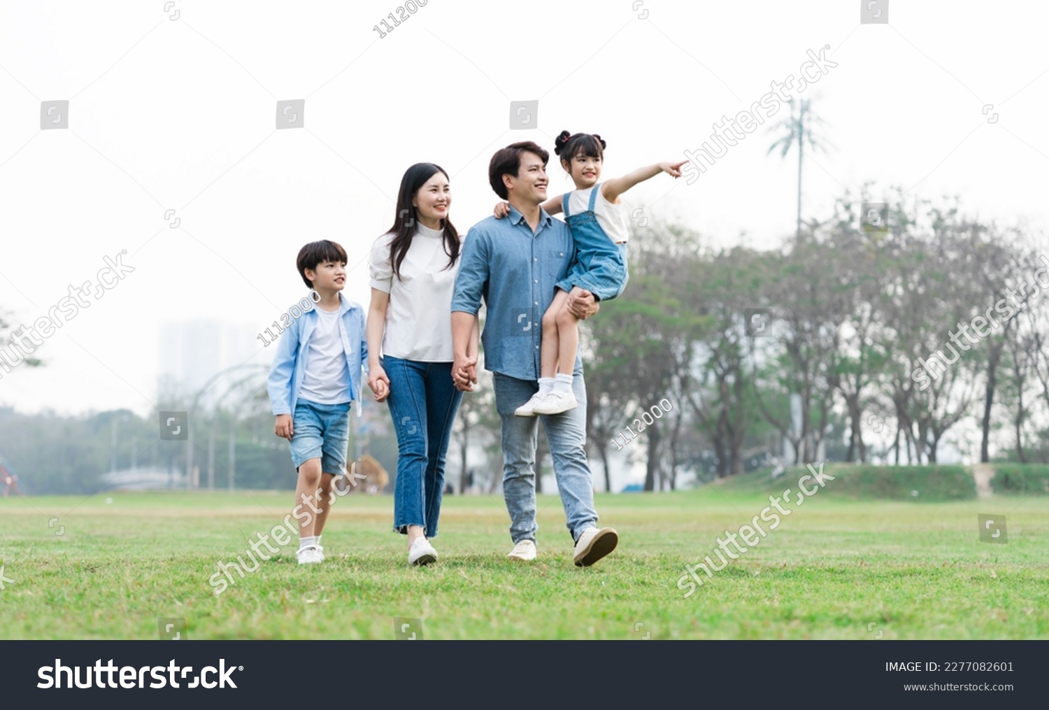 Asian family photo walking together in the park #2277082601