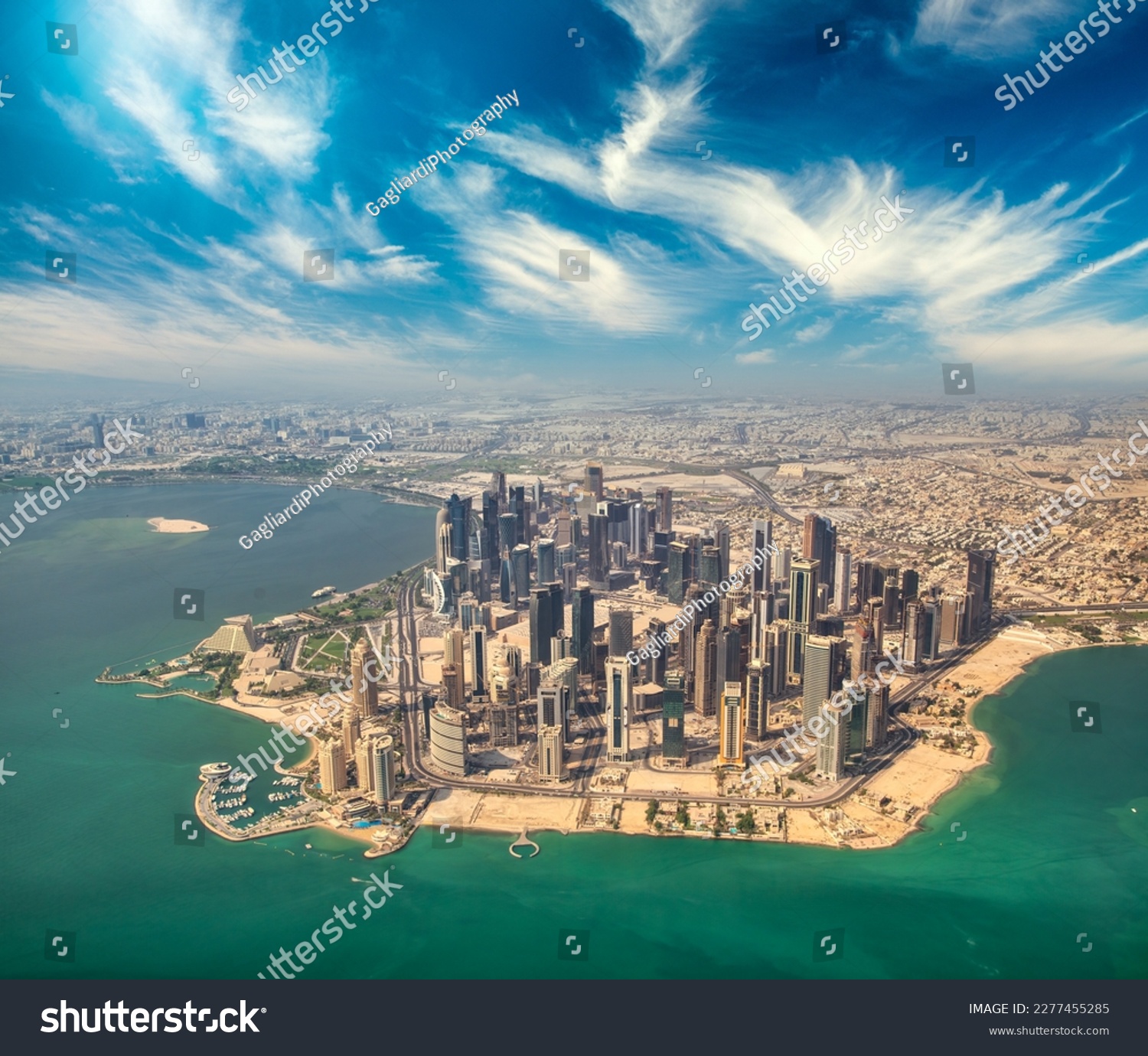 Aerial view of Doha skyline from airplane. Modern skyscrapers at sunset, Qatar. #2277455285