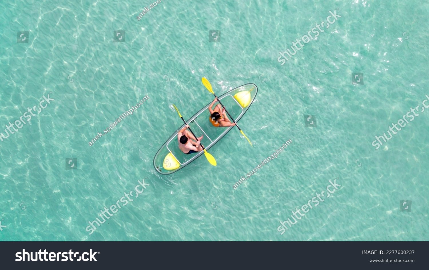 Asian couple travel Pataya by use kayak boat togather on on clean sea water from top view in Thailand #2277600237