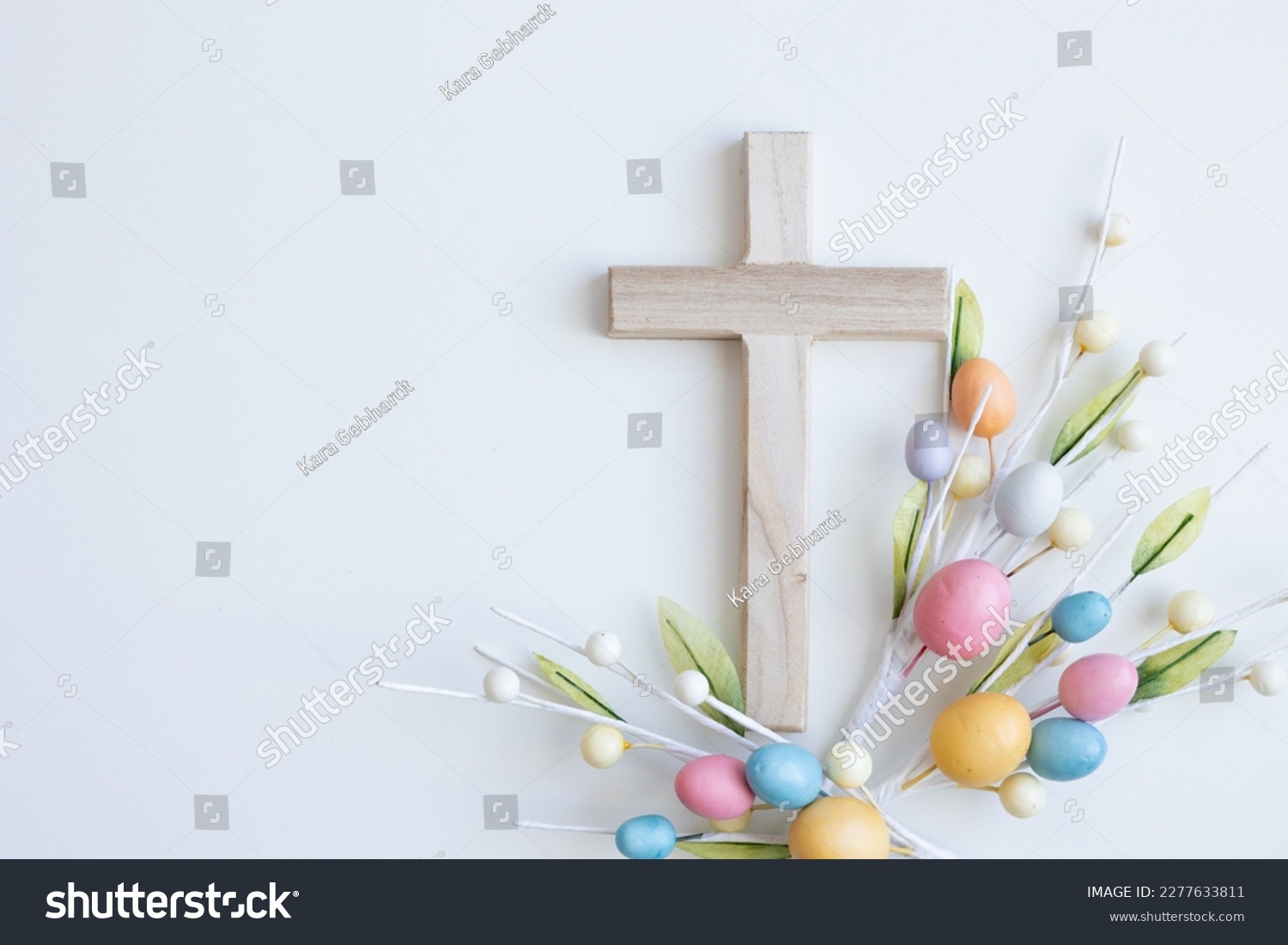 Cross with Easter eggs on a white background with copy space  #2277633811