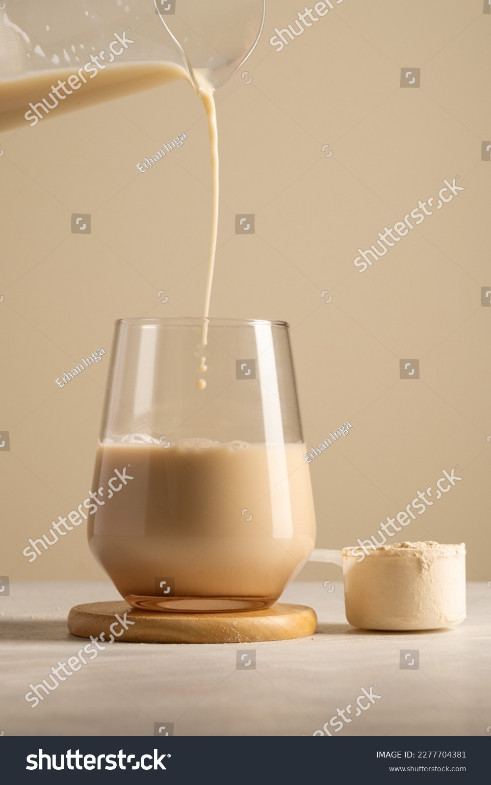 Protein powder. Pouring chocolate drink in a glass. #2277704381
