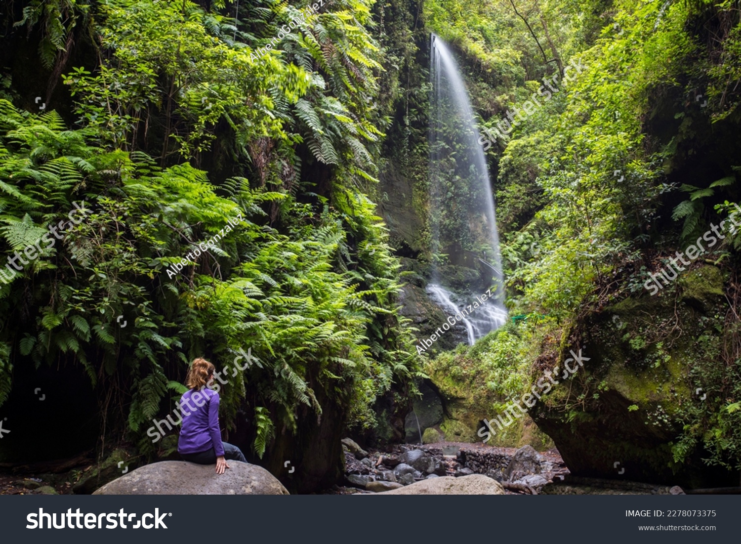 A young woman in Tilos waterfall, La Palma Island, Canary Islands, Spain. #2278073375