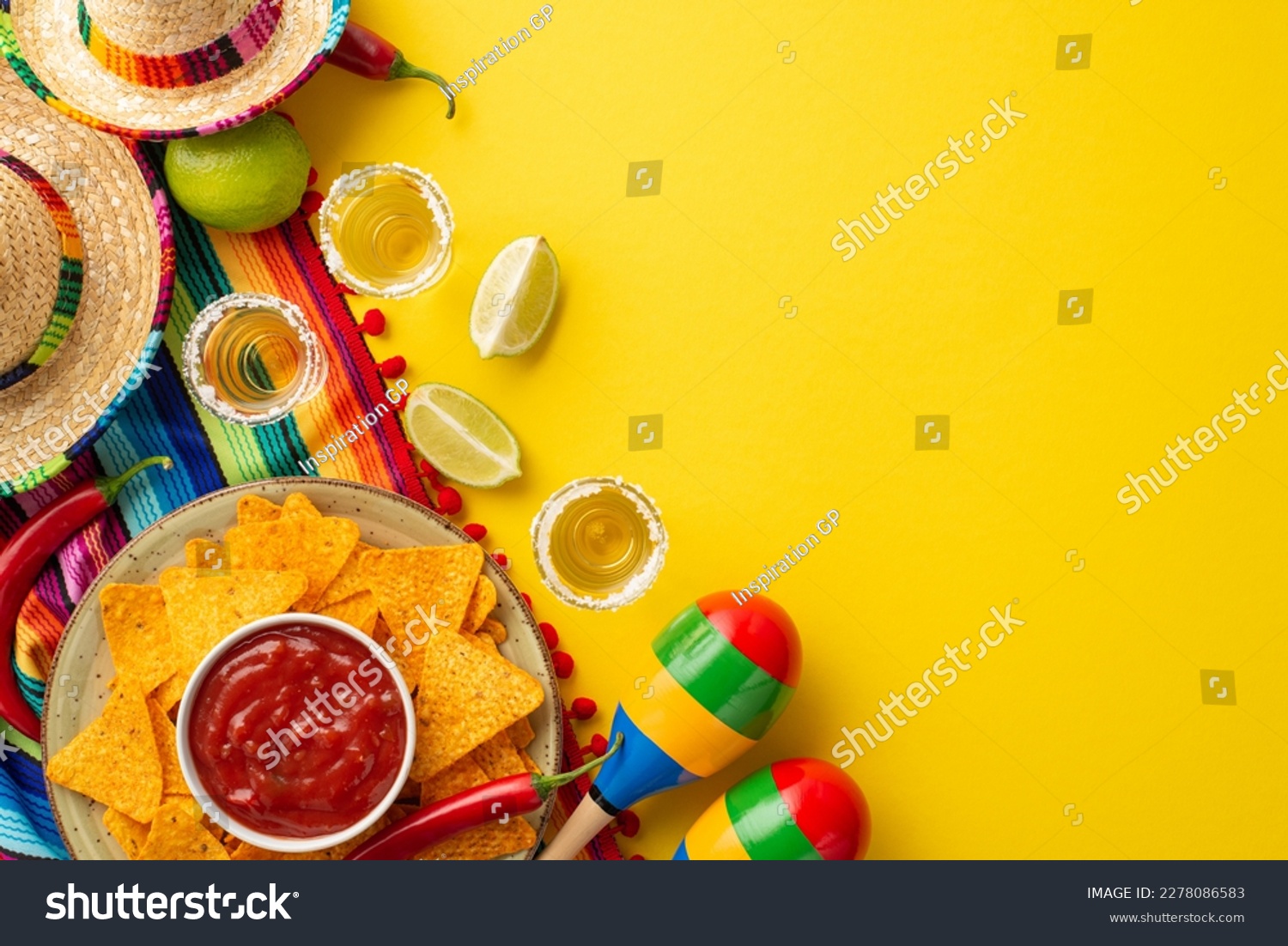 Cinco-de-mayo concept. Top view photo of nacho chips salsa sauce hot pepper tequila with salt and lime sombrero colorful striped serape and maracas on isolated vivid yellow background with copyspace #2278086583