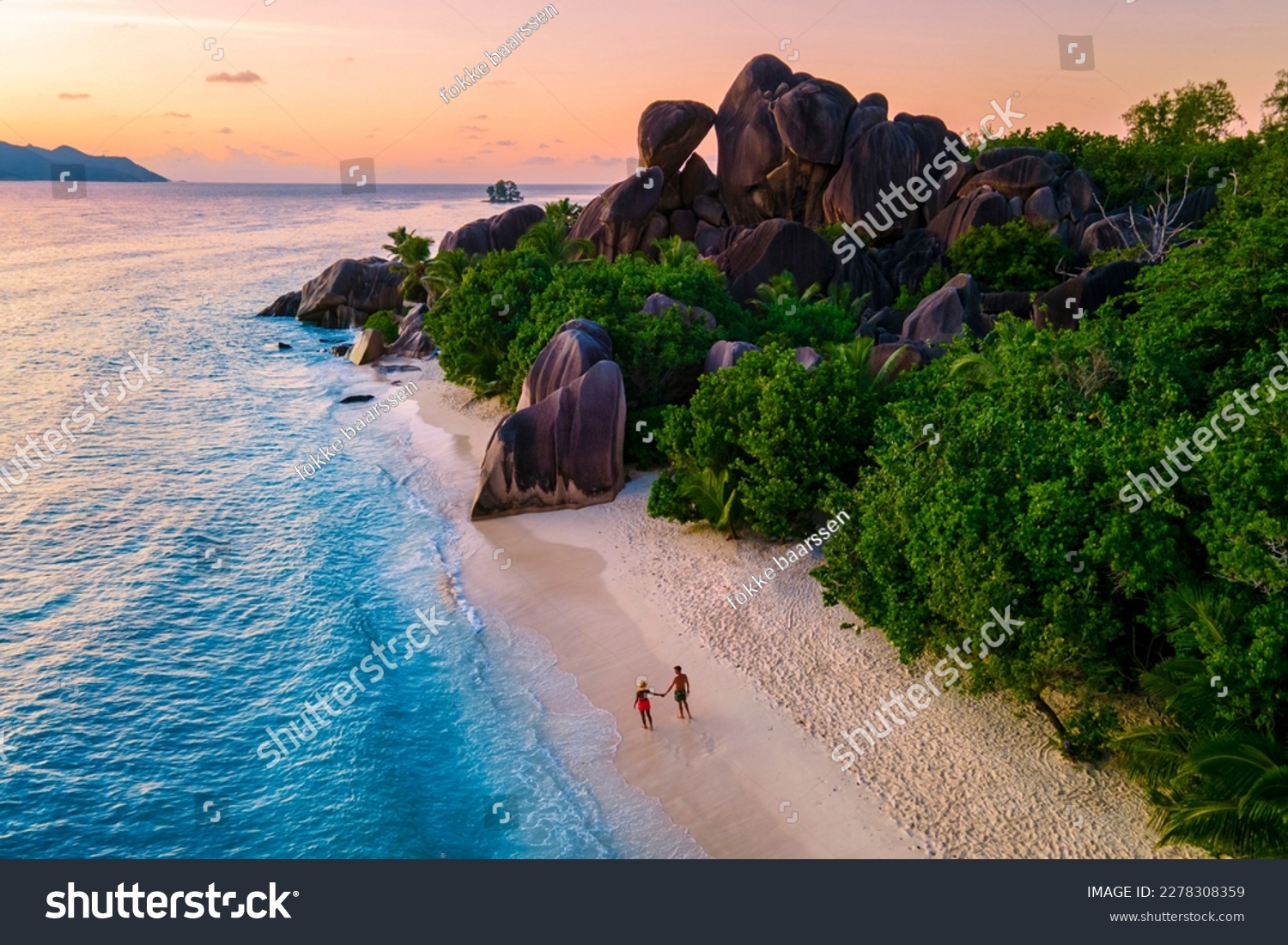 Anse Source d'Argent, La Digue Seychelles, a young couple of Caucasian men and Asian women on a tropical beach during a luxury vacation in Anse Source d'Argent, La Digue Seychelles #2278308359