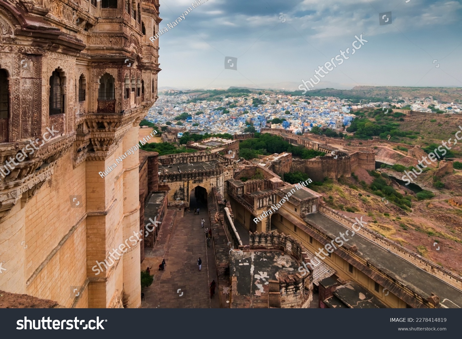 Top view of Mehrangarh fort with distant view of blue city Jodhpur, Rajasthan, India. Blue sky with white clouds in the background. Historical Fort is UNESCO world heritage site #2278414819