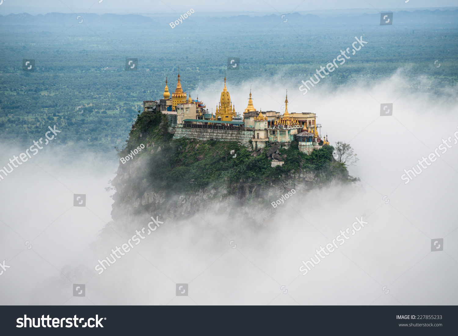 Spectacular view of Mount Popa over the clouds. Mt.Popa is the home of "Nat" the Burmese mythology ghost. This place is the old volcano in Myanmar. #227855233