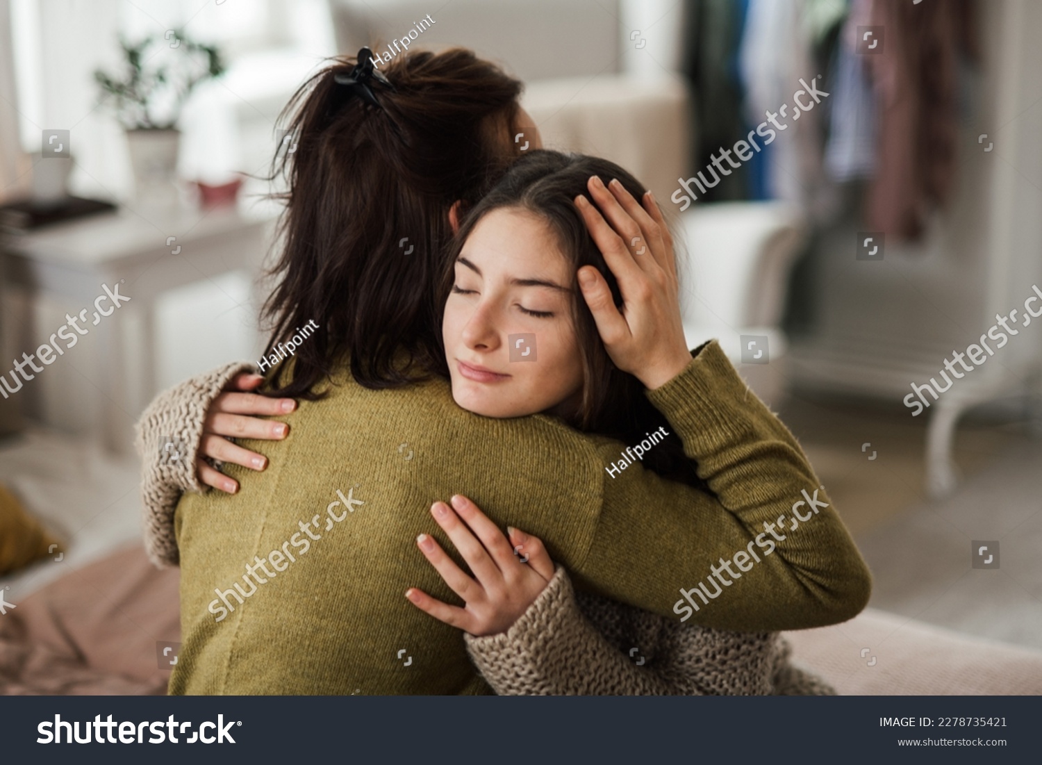 Teenage girl hugging her mother at home. #2278735421