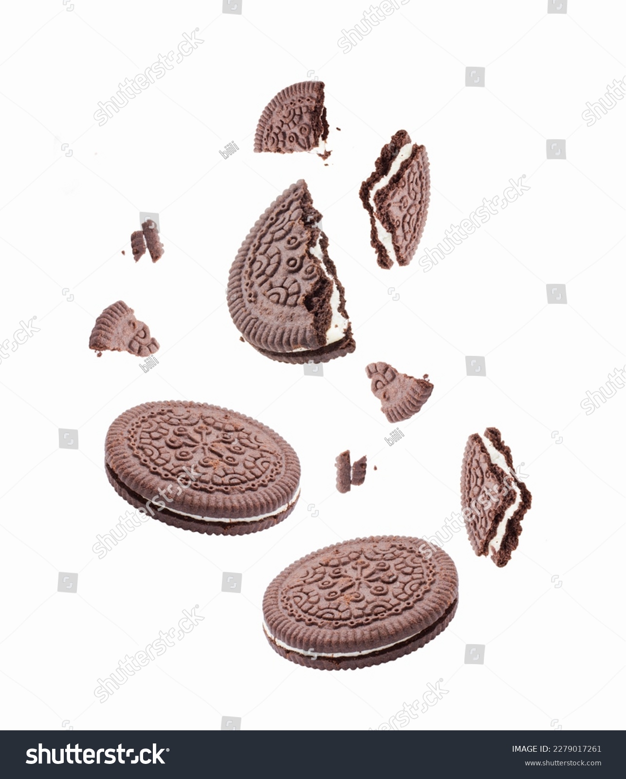 Chocolate cookies or biscuits, with  vanilla cream filling, falling on white background #2279017261