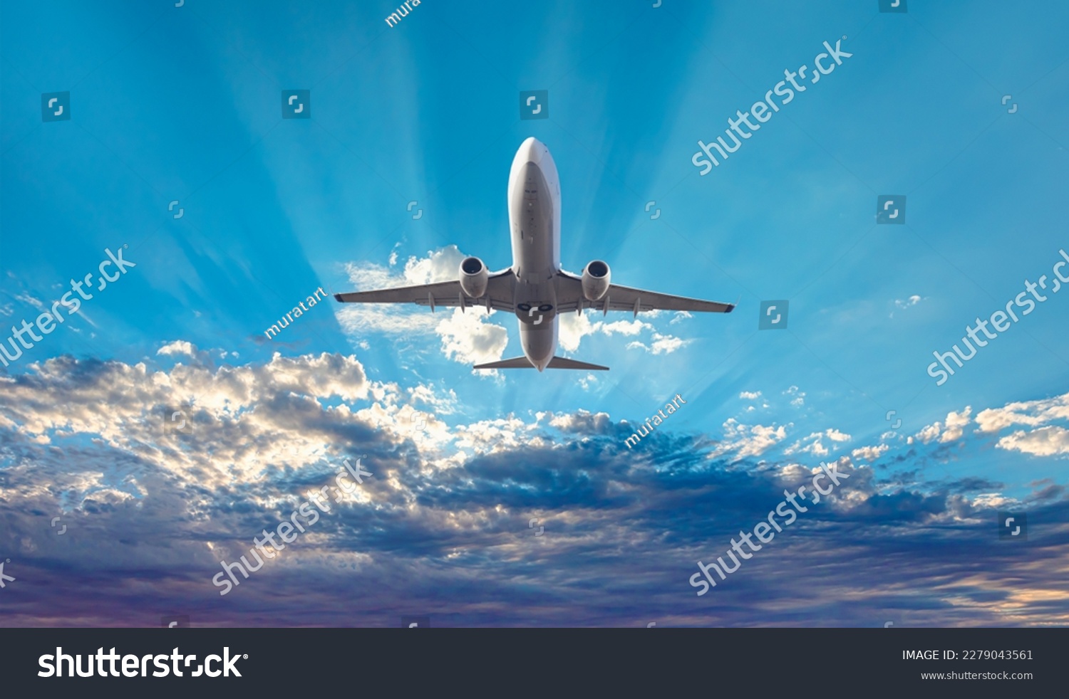 White passenger airplane flying in the sky amazing clouds in the background - Travel by air transport #2279043561