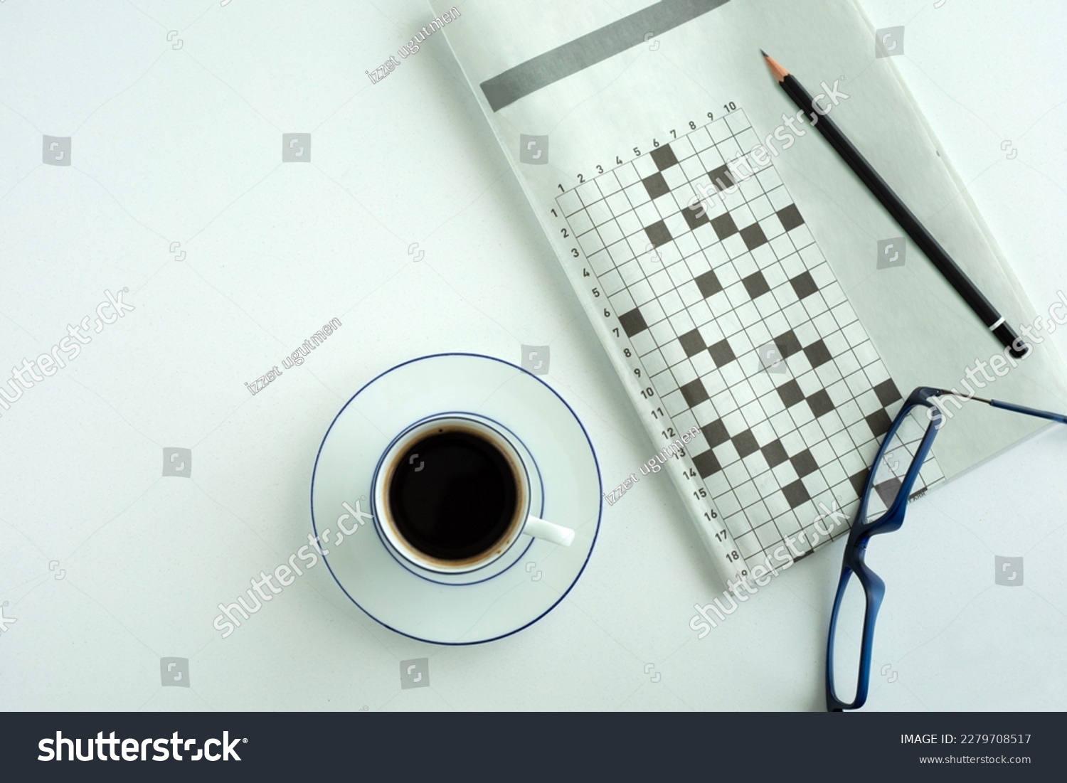 crossword paper with eyeglasses and coffee cup #2279708517