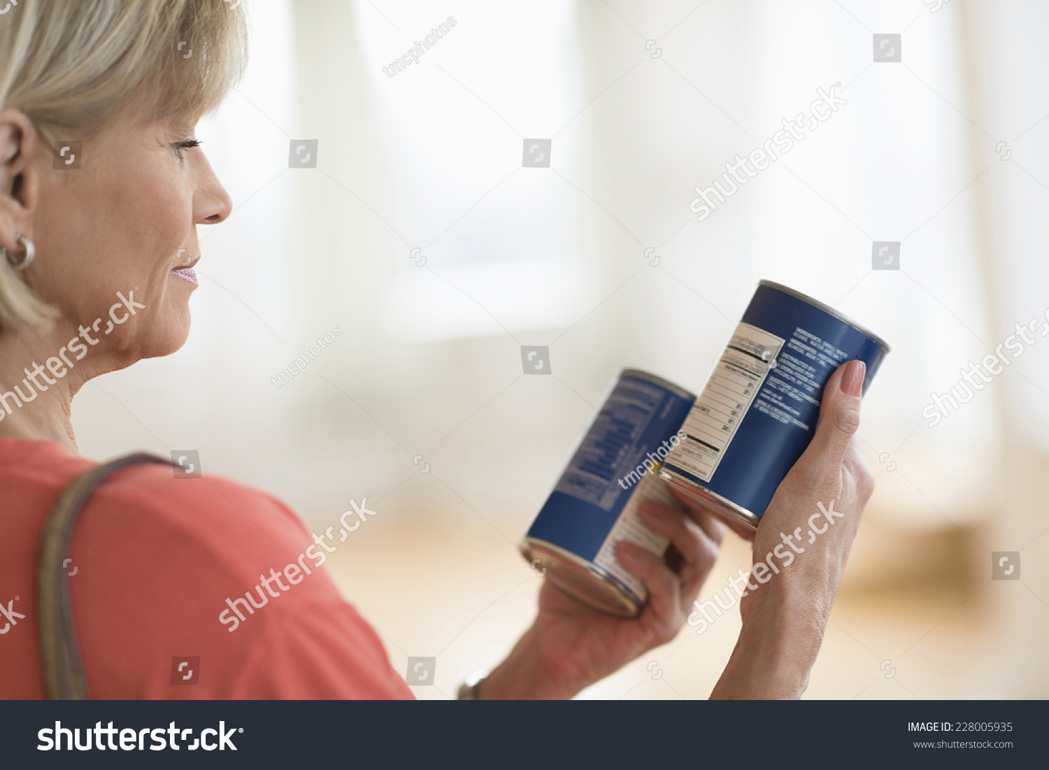 Cropped image of woman comparing products in shop #228005935