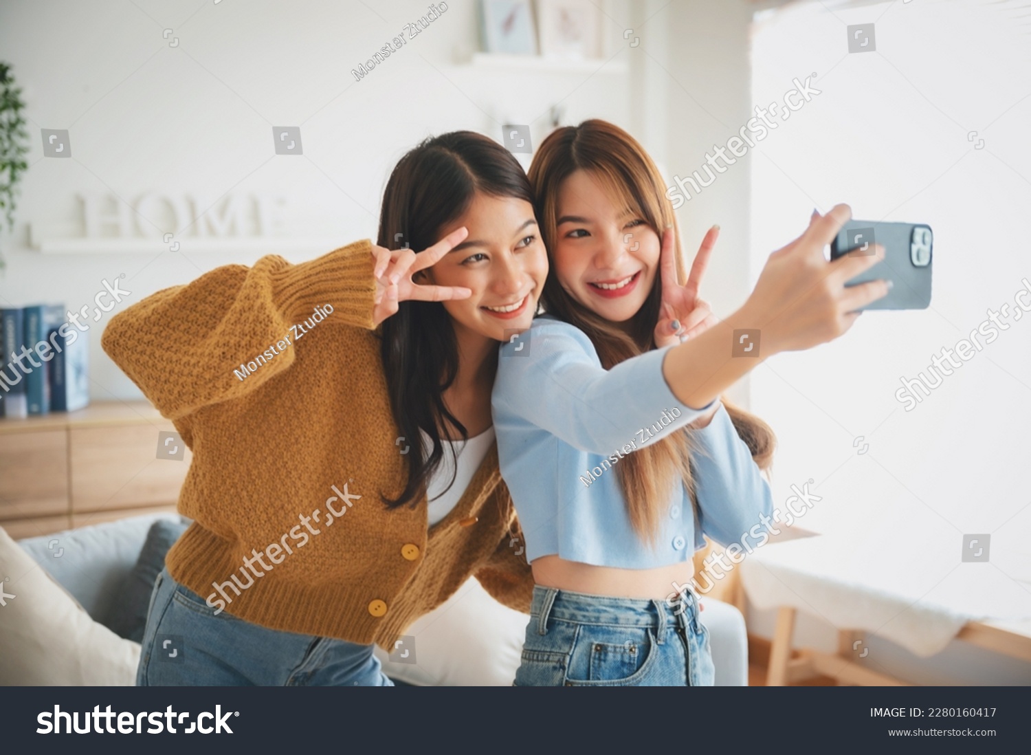 Two asian young women happy smiling and taking selfie in living room at home. Video call, Meeting conference #2280160417