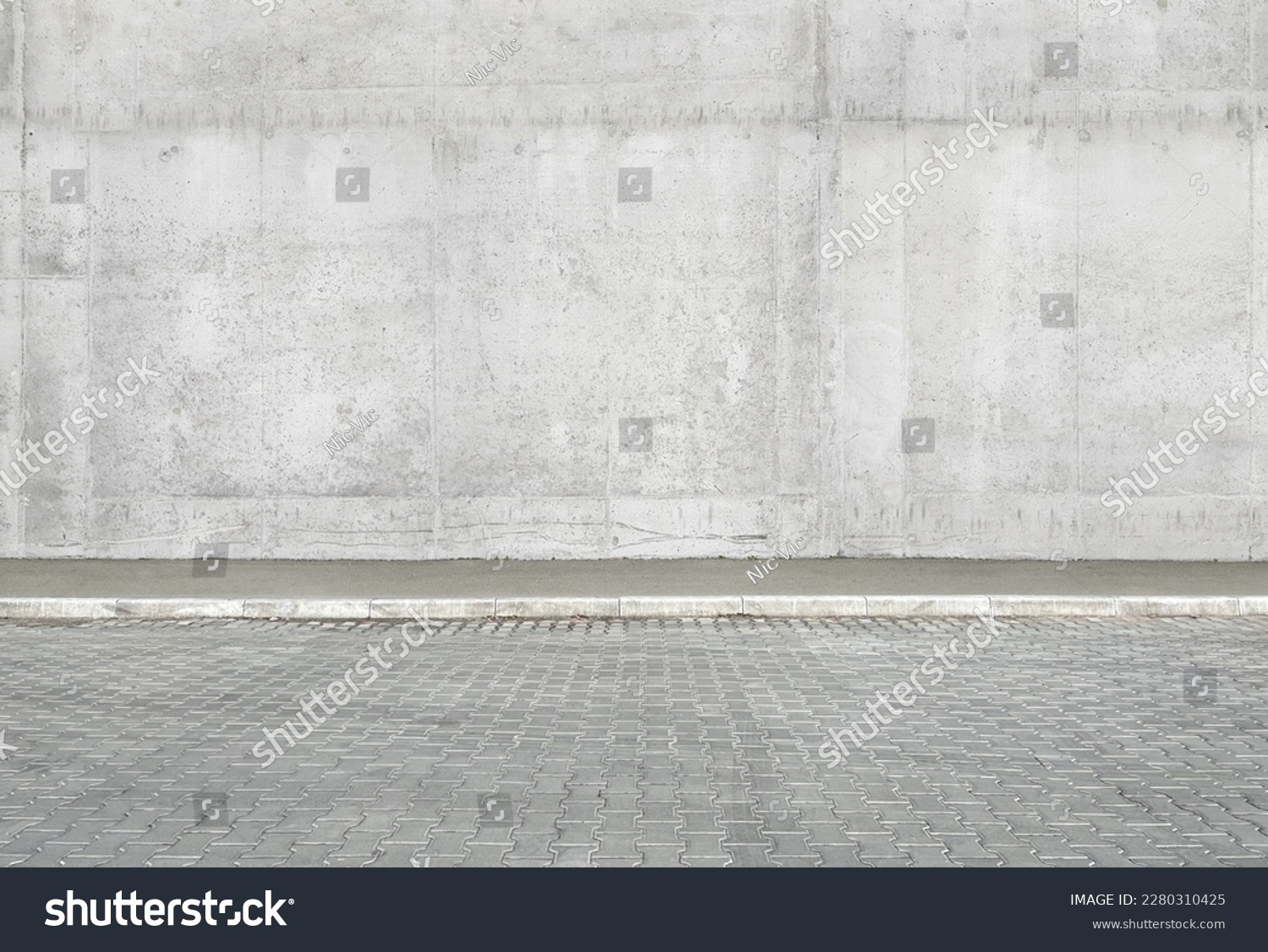 a fragment of a street city concrete wall of a building and an paving stones. Building's facade. Mocap or background for creativity #2280310425