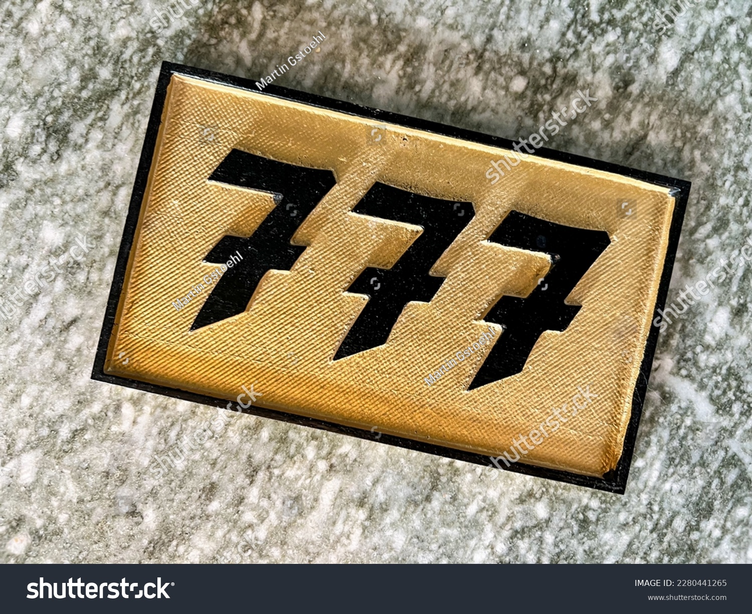 High angle view of golden house number plate on granite underground #2280441265