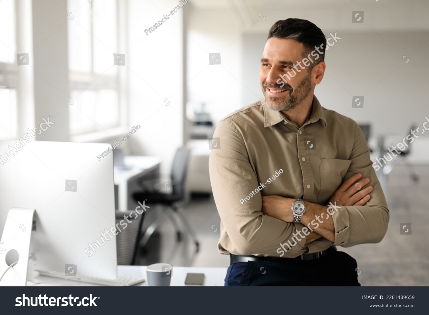 Happy middle aged businessman standing by his workplace, looking aside at copy space, thinking of new startup or project, smiling at good thoughts, planning investment, enjoying success #2281489659