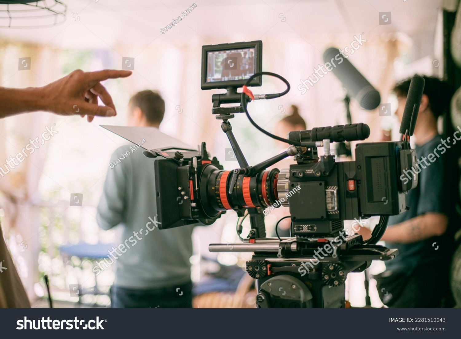 Professional cinema and video camera on the set. Shooting shift, lighting fixtures, shooting equipment and the team. Technique of modern filming and advertising. #2281510043