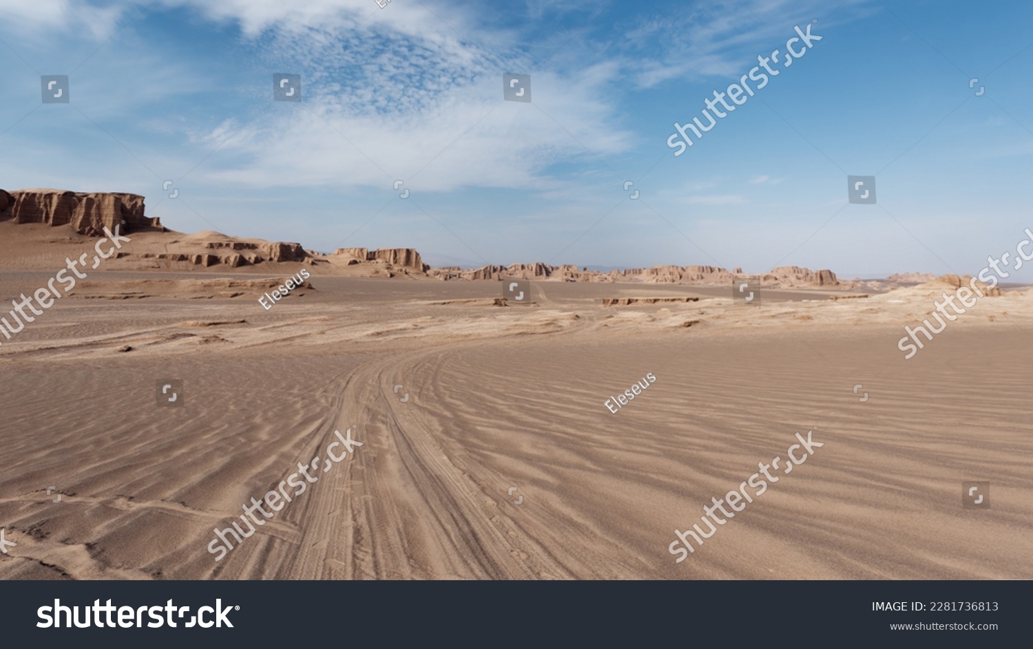  Low-angle view of the car trails in the sand and formations known as Kaluts in the background, Dasht-e Lut Desert, Iran #2281736813
