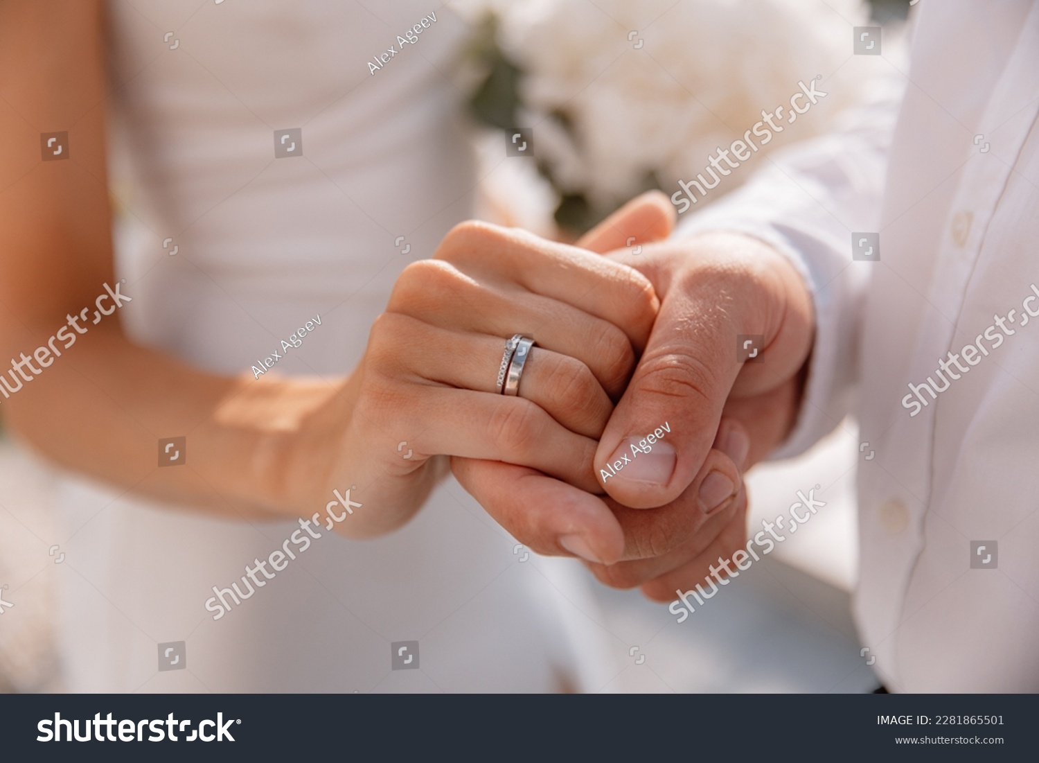 Close-up photo of the men`s holding woman hand with golden wedding ring with diamond. Wedding ring before the proposal. Luxury wedding rings #2281865501