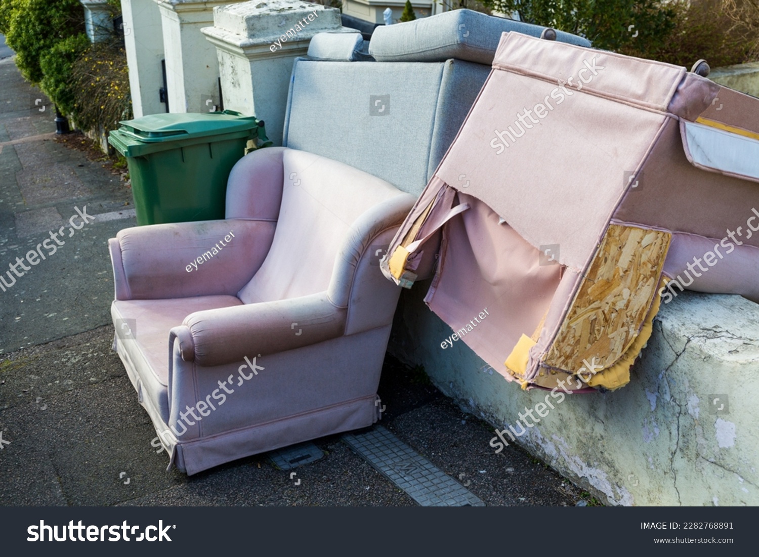 Bulky discarded furniture including armchairs and a settee left outside a house in St Leonards-on-Sea awaiting collection #2282768891