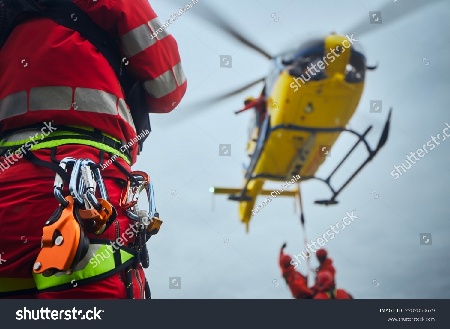 Selective focus on safety harness of paramedic of emergency service in front of helicopter. Themes rescue, help and hope.
 #2282853679