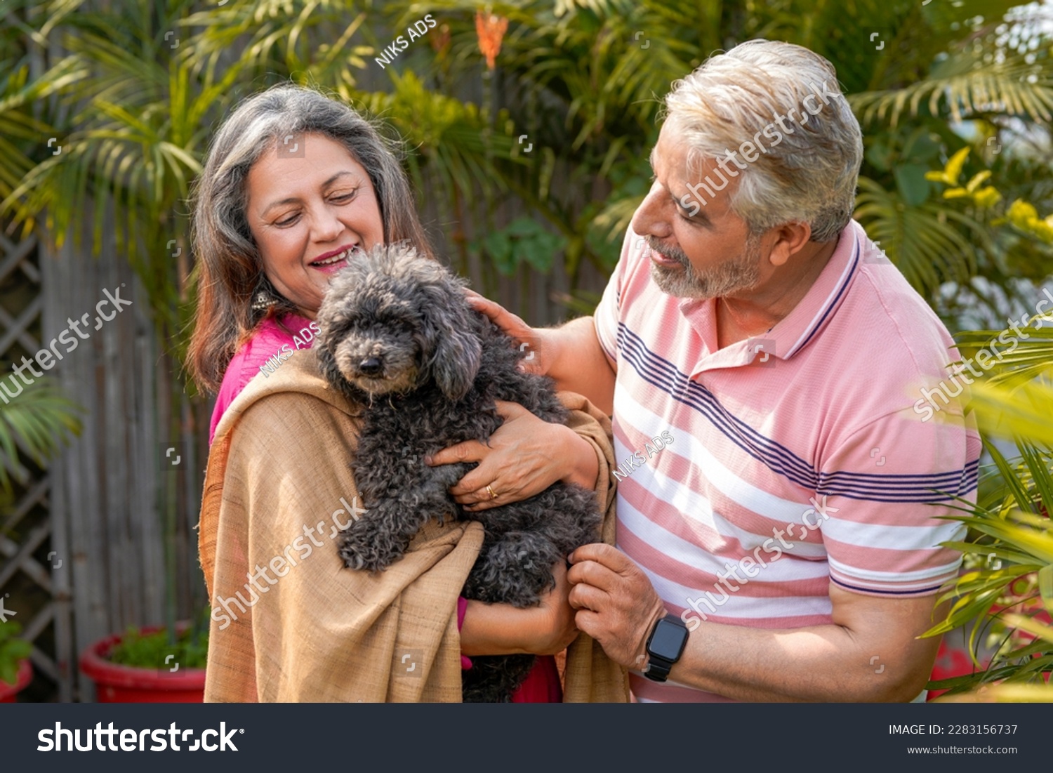 Senior couple loving with dogy puppy. concept about pets and animals. #2283156737