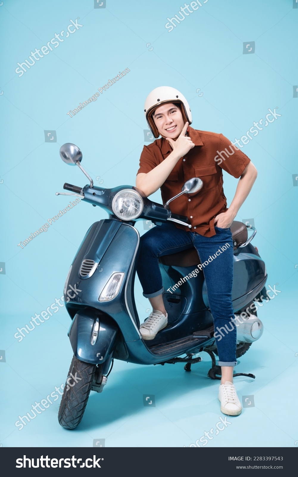 Image of yougn Asian man on motorbike #2283397543