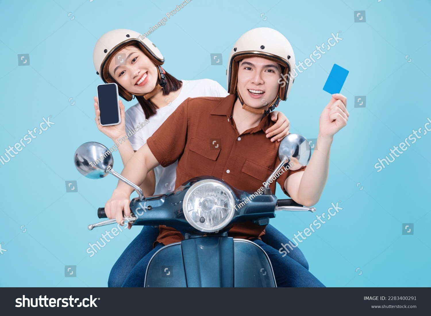 Young Asian couple ride scooter on background #2283400291