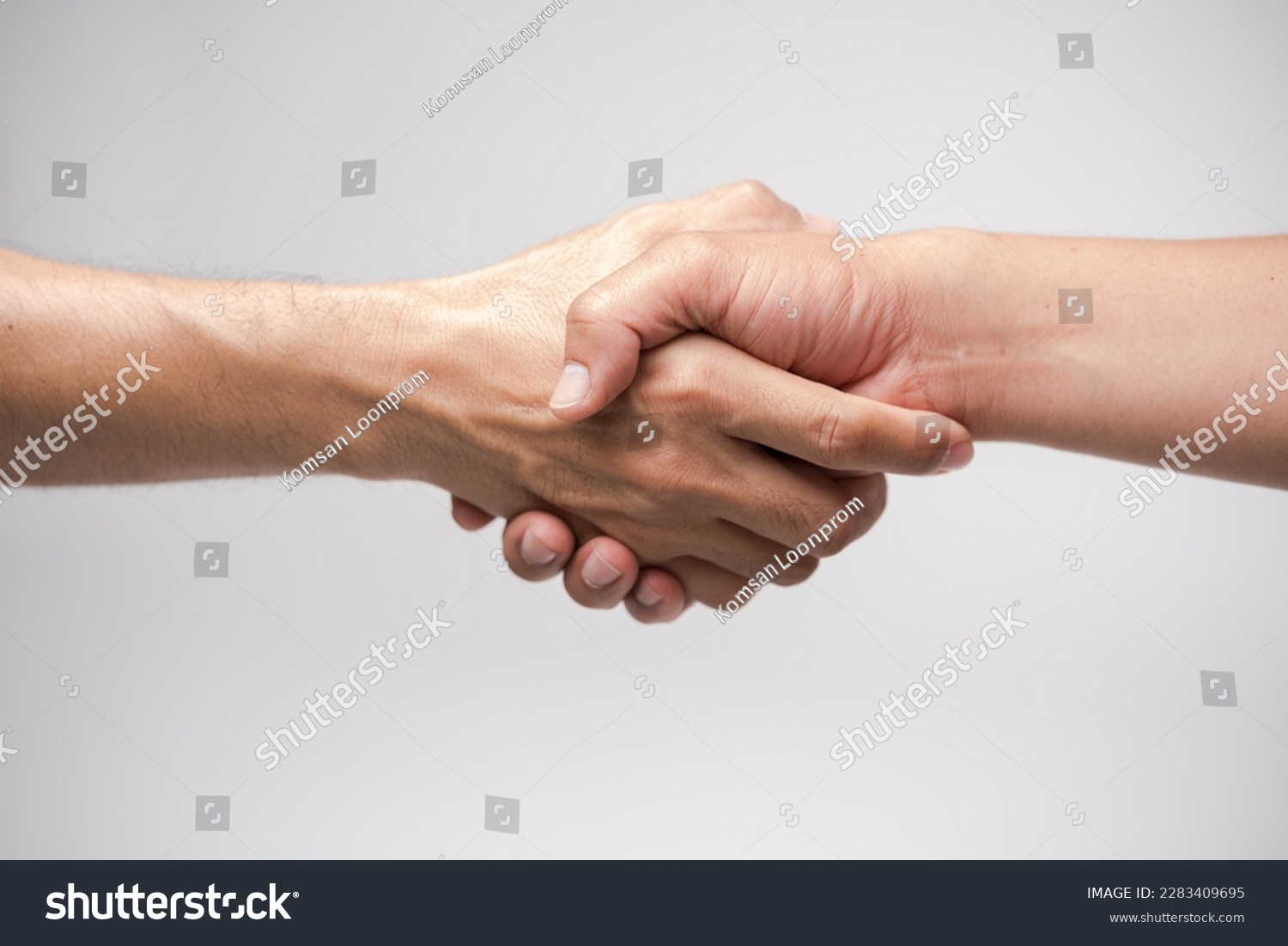Close up two man shaking hand on white background.Athletes shaking hands before sports competition. Unity and teamwork concept. #2283409695
