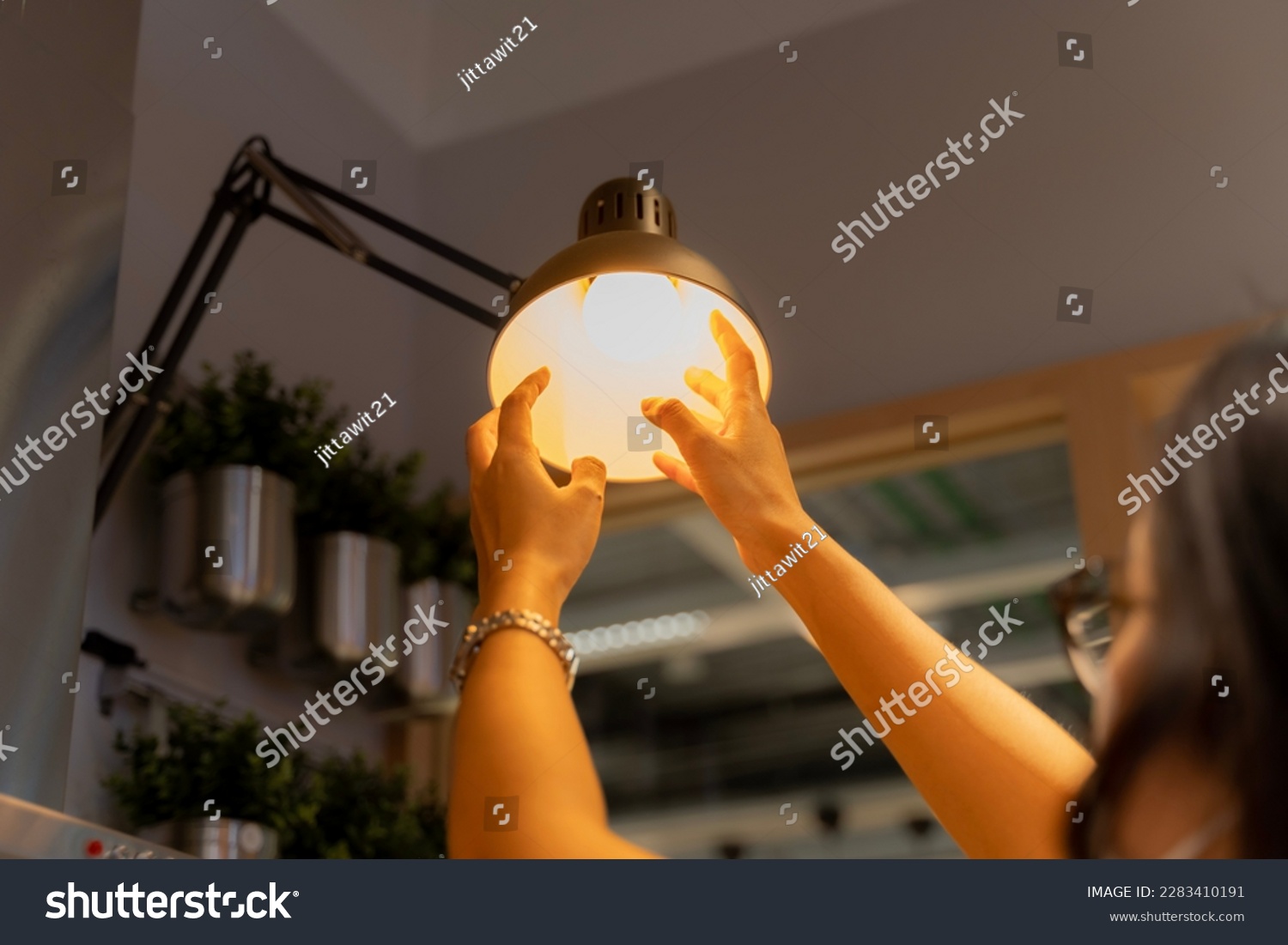 Hand woman changing with new LED lamp light bulb,Power saving concept. Reusing and recycling existing materials for future growth of business and environment sustainable.  #2283410191