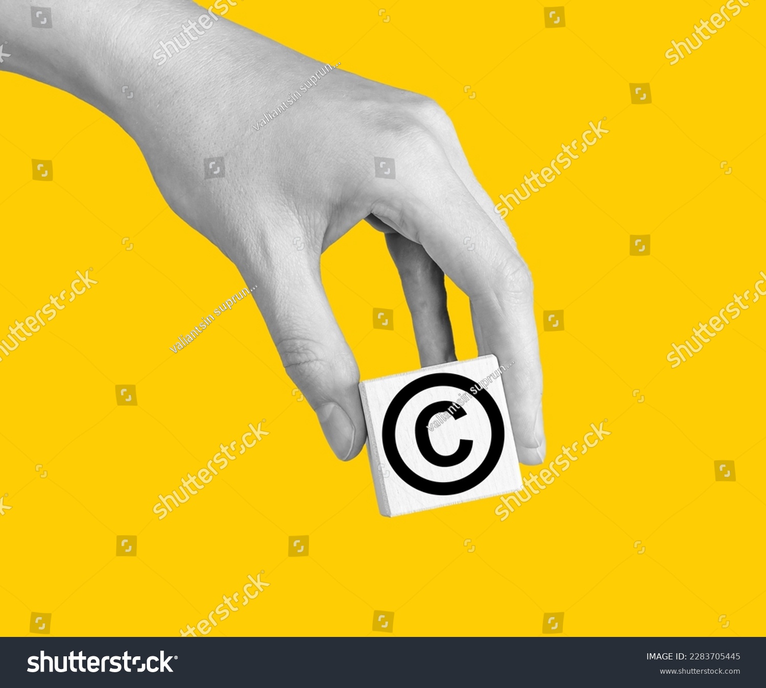 World copyright day. Hand with intellectual property protection, patent law sign in circle on cube. High quality photo #2283705445
