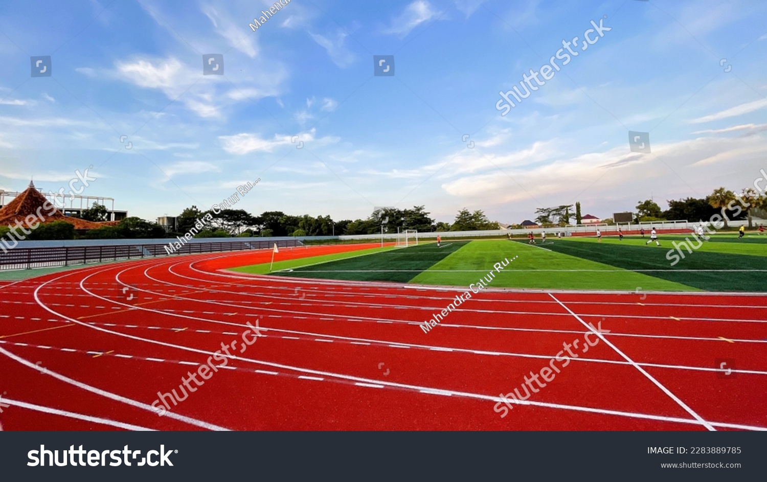 The running track inside a football stadium is usually a circular pathway surrounding the field. #2283889785