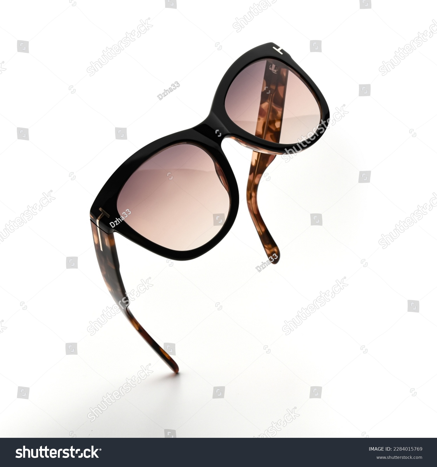 Sunglasses in flying isolated on white and grey background. Sunglasses summer woman fashion accessories as design element for promo or advertising banner. Glasses black leopard color with vintage #2284015769