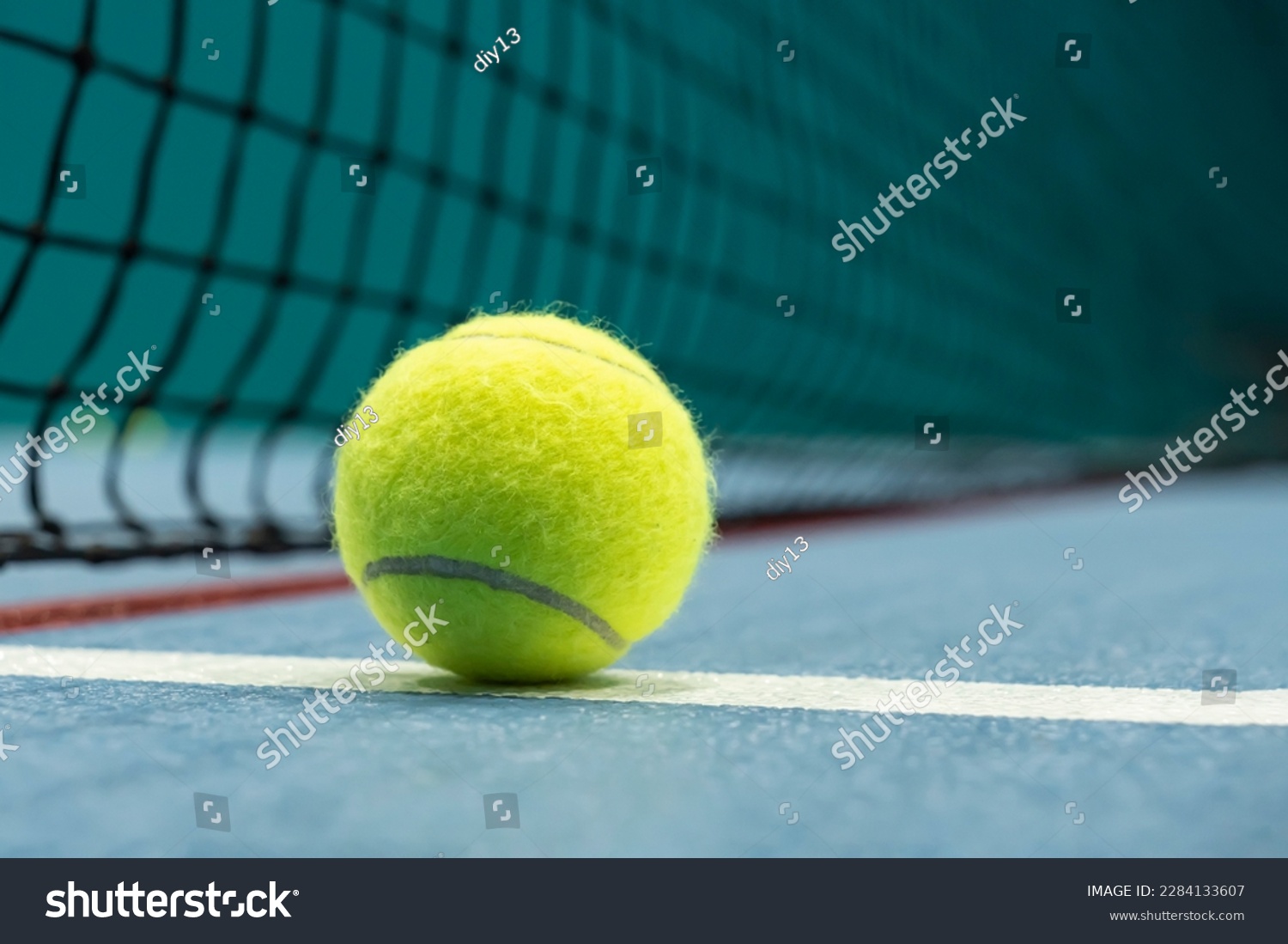 Tennis ball on blue tennis court. the concept of a sporty lifestyle. #2284133607