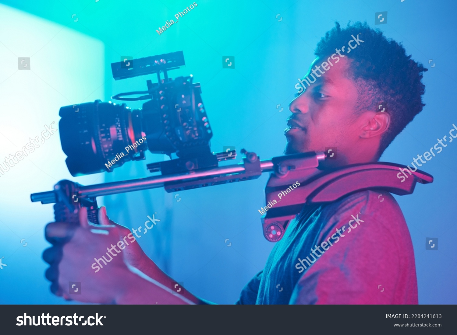 Young African American professional operator making video content using special equipment and professional camera #2284241613