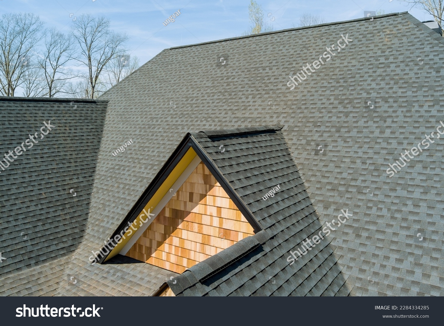 When installing top covering of asphalt shingles on new house quality roof work is inspected #2284334285