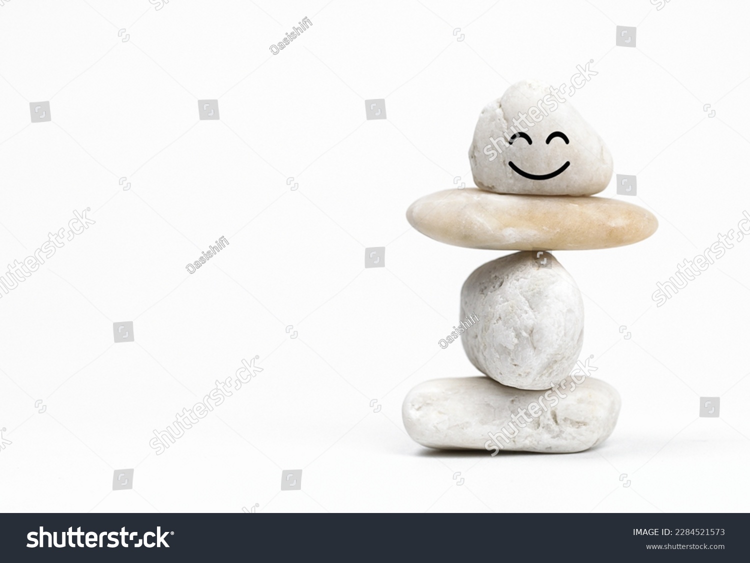 Positive Mind and  Harmony, Enjoying Life Concept, Hand Setting Natural Pebble Stone with Smiling Face Cartoon to Balance. Balancing Body, Mind, Soul and Spirit. Mental Health Practice.                #2284521573