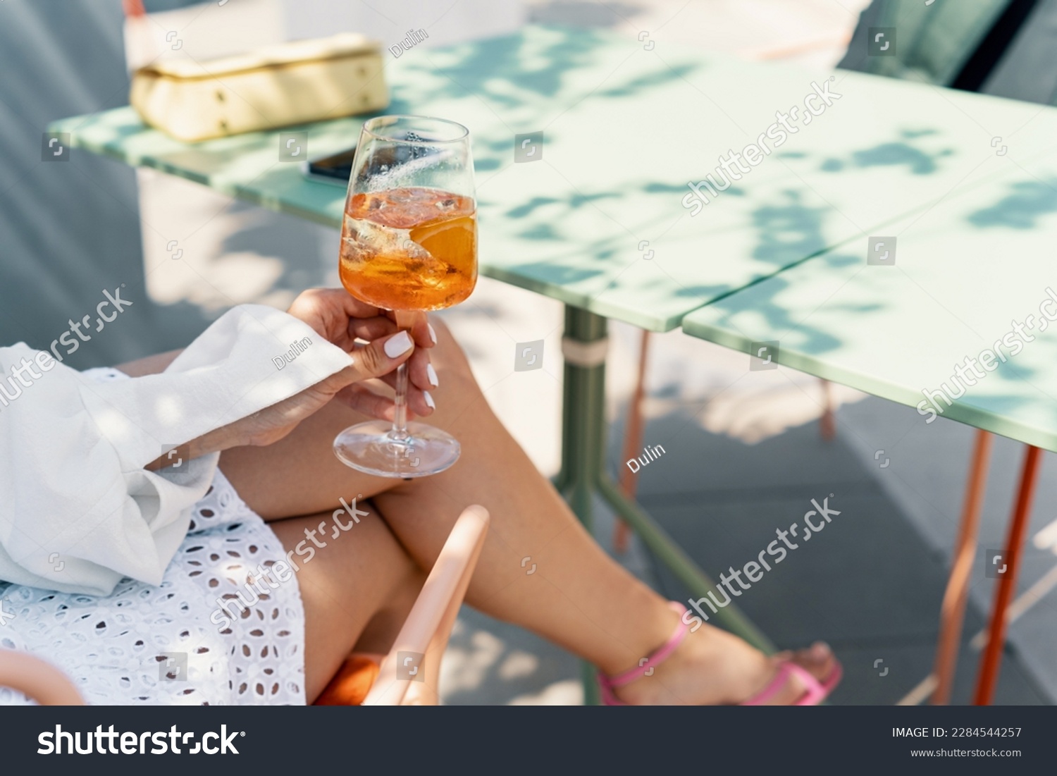 Woman drinking iced summer cocktail aperol spritz #2284544257