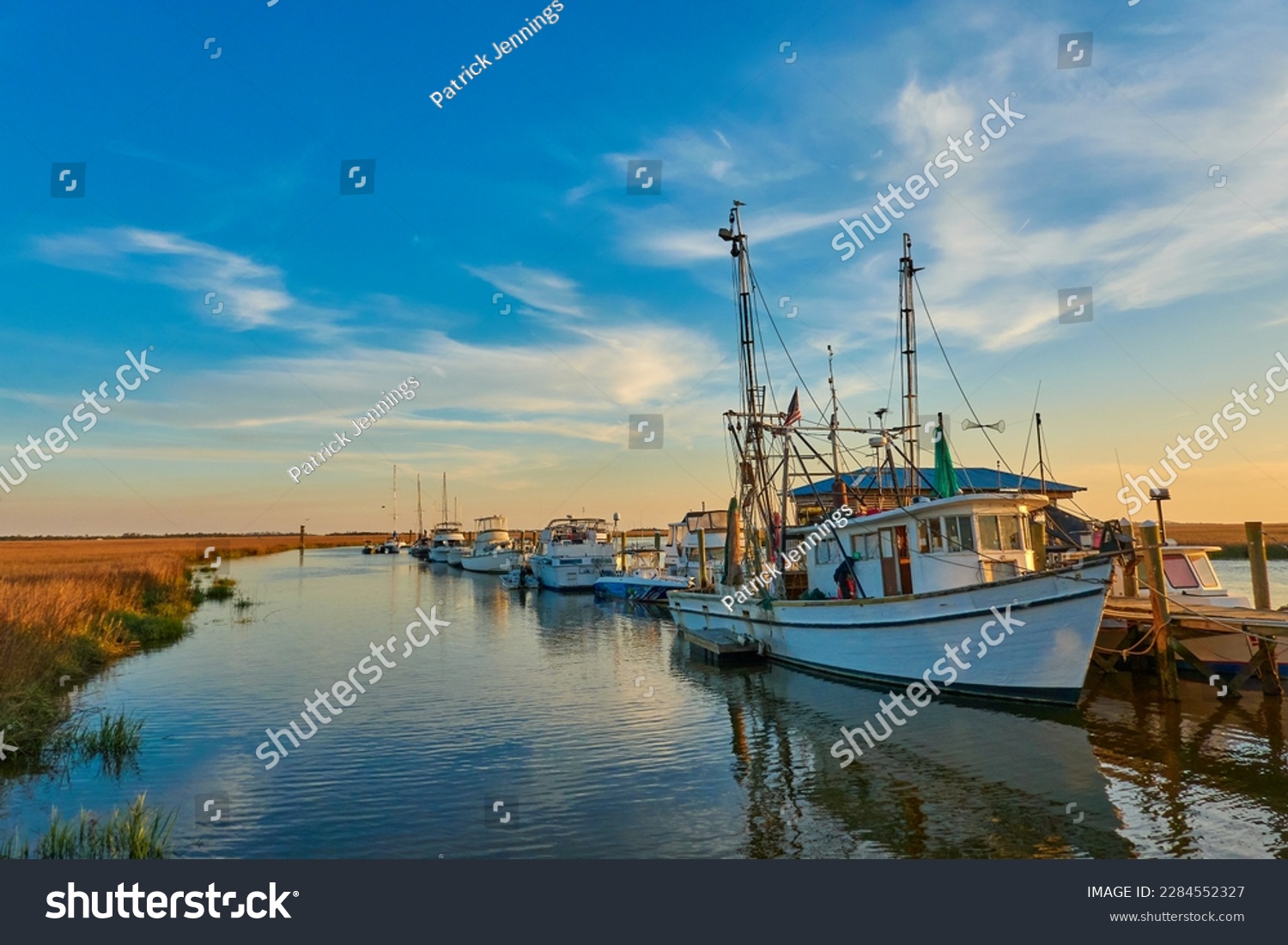 Sunset with shrimp boats along a dock at Tybee Island, Ga. #2284552327