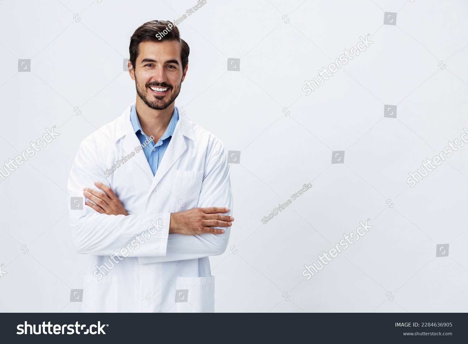 Man doctor in a white coat with a stethoscope smile with teeth and good test results looking into the camera on a white isolated background, copy space, space for text, health #2284636905