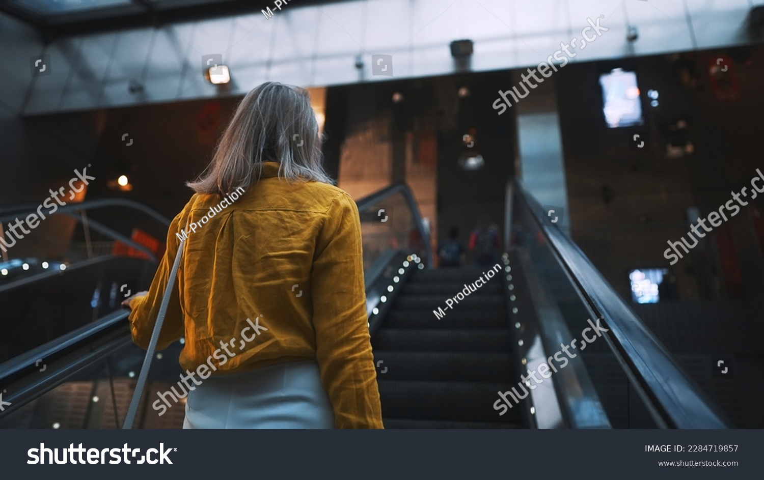 Woman using the escalator in the subway. #2284719857