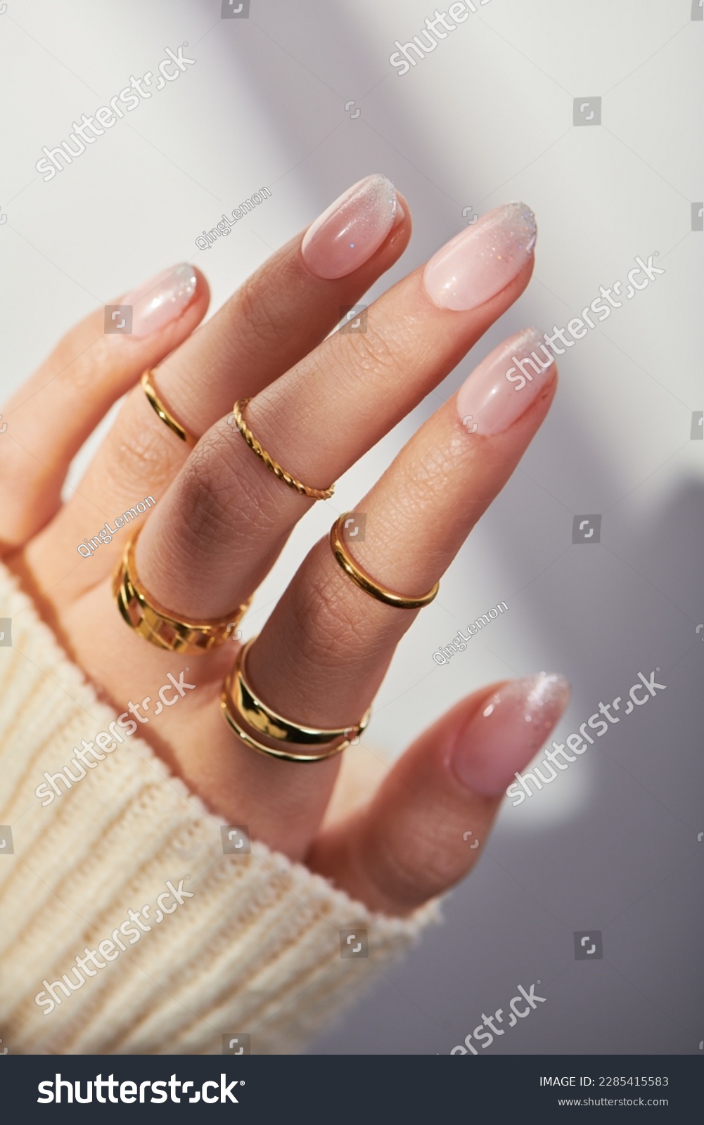 Female hands with rose nail design. Pink glitter nail polish manicure. Woman hands on white background.  #2285415583